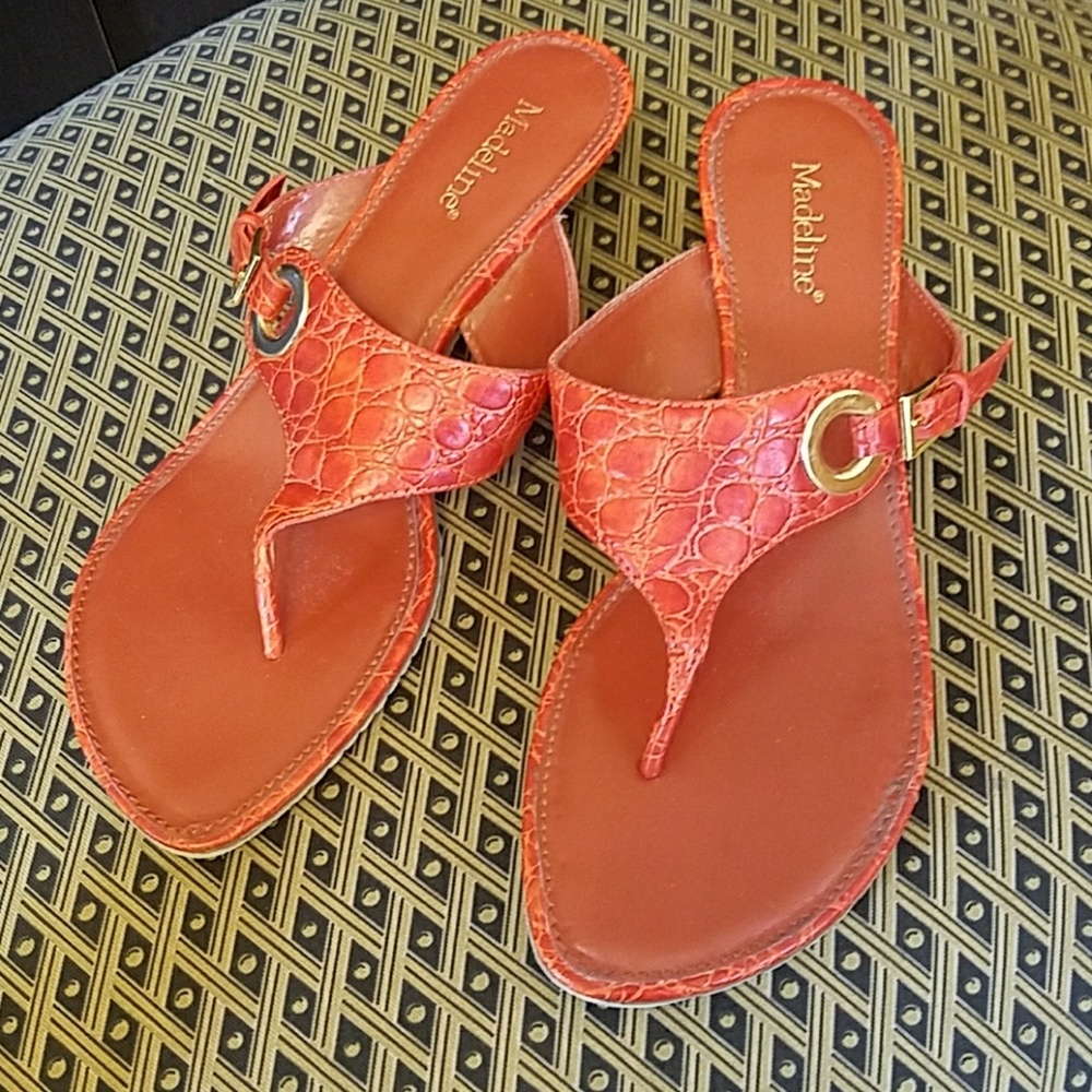 Red sandals with wooden kitten heels.